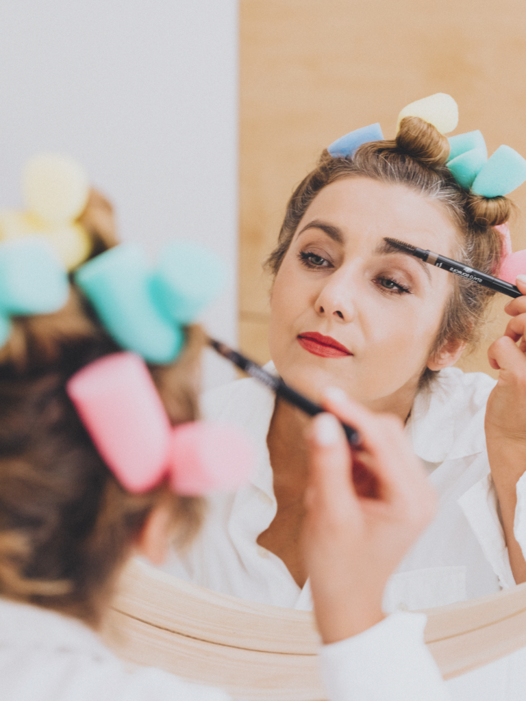 woman doing her makeup and getting ready for work