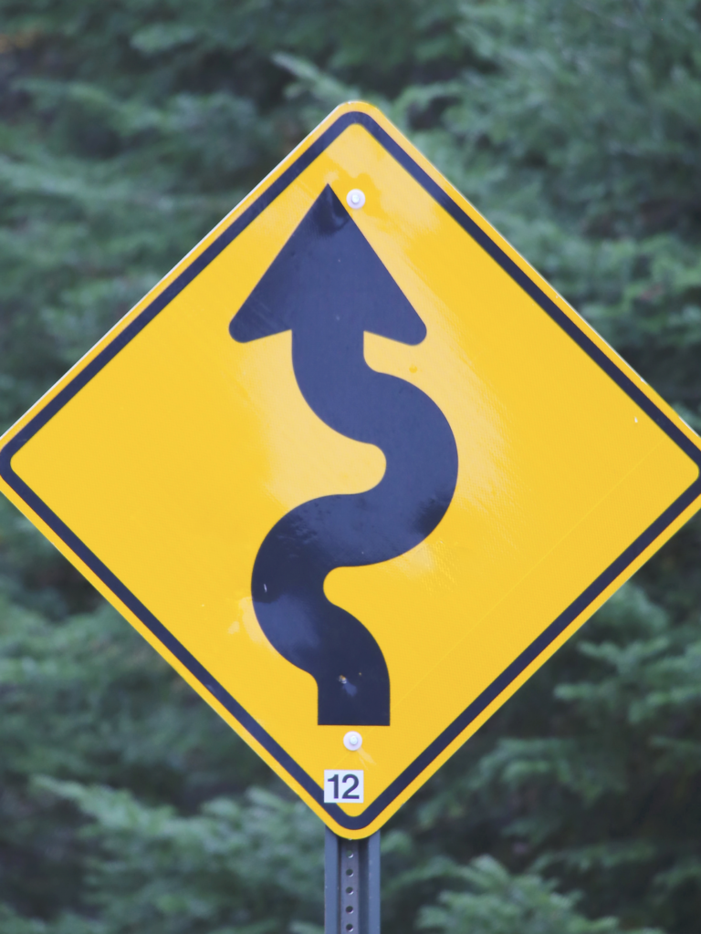 Winding road, road sign.