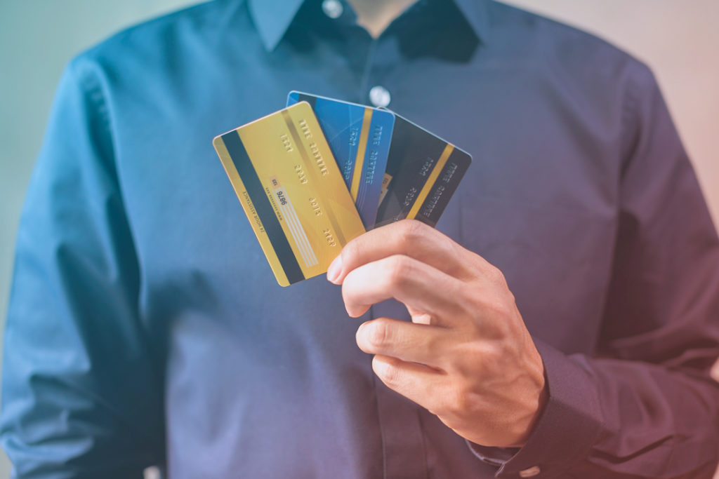 man holding credit cards
