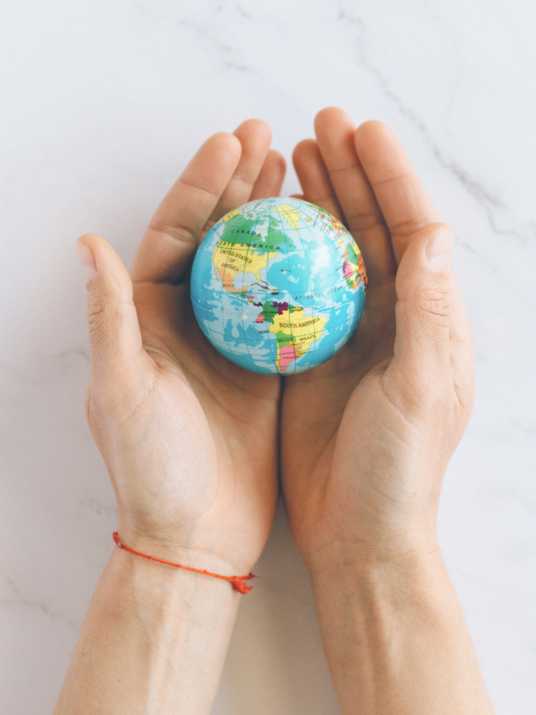 hands holding small globe