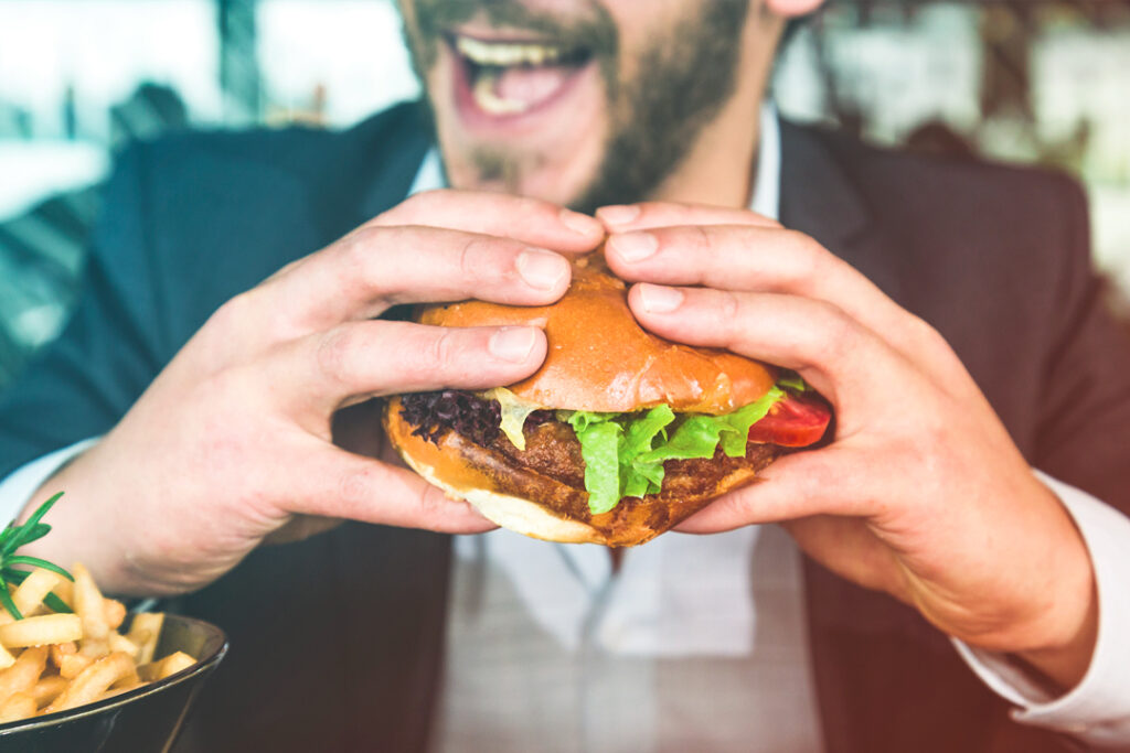 business man eating a hamburger