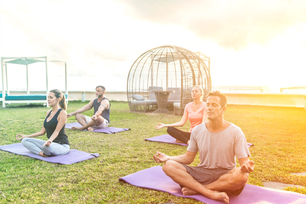 a group taking a yoga class outside