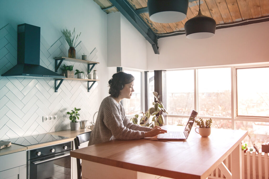 employee working from kitchen of a rental house