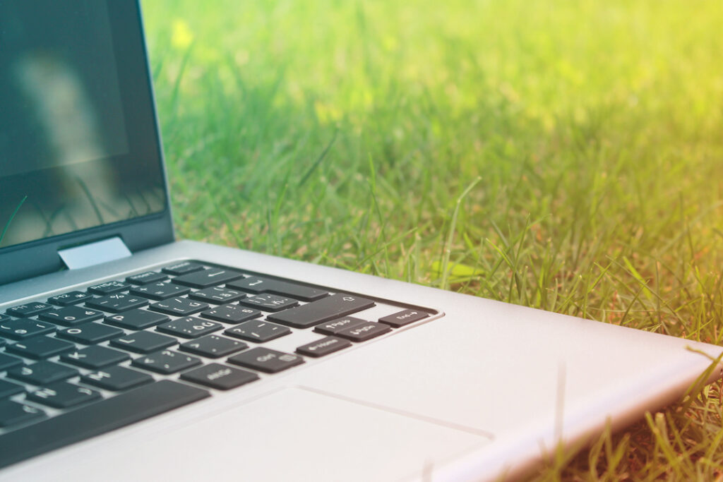 Laptop computer on grass outside
