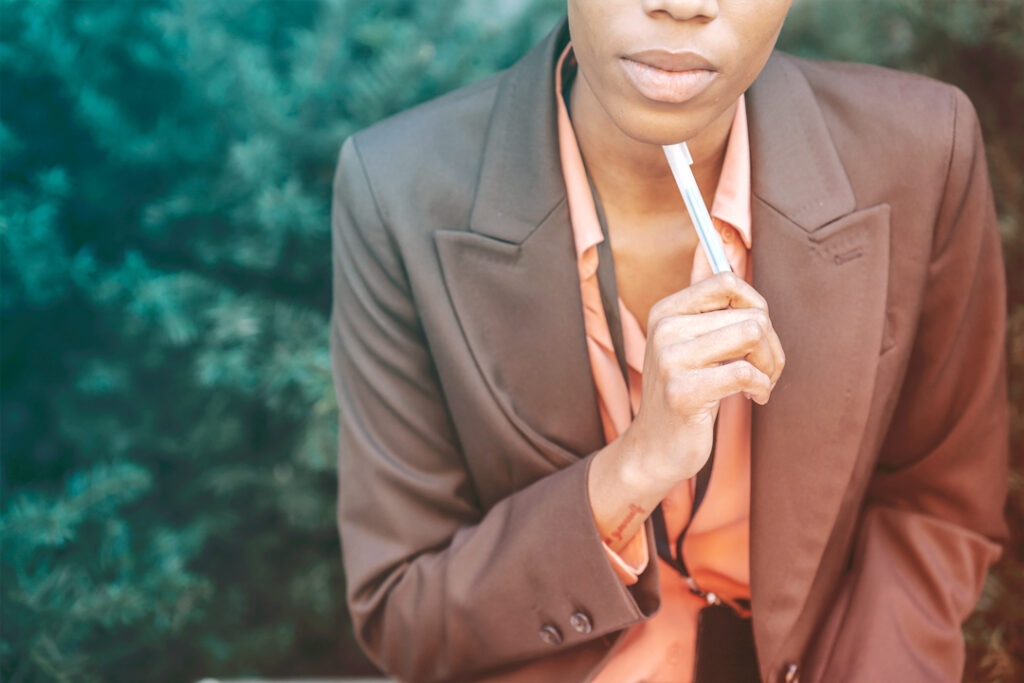 business woman siting outside thinking