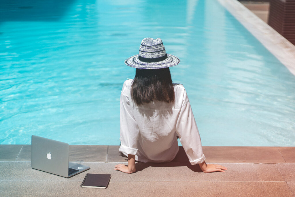 business woman working by the hotel pool