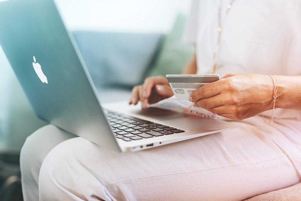 employee booking travel on laptop
