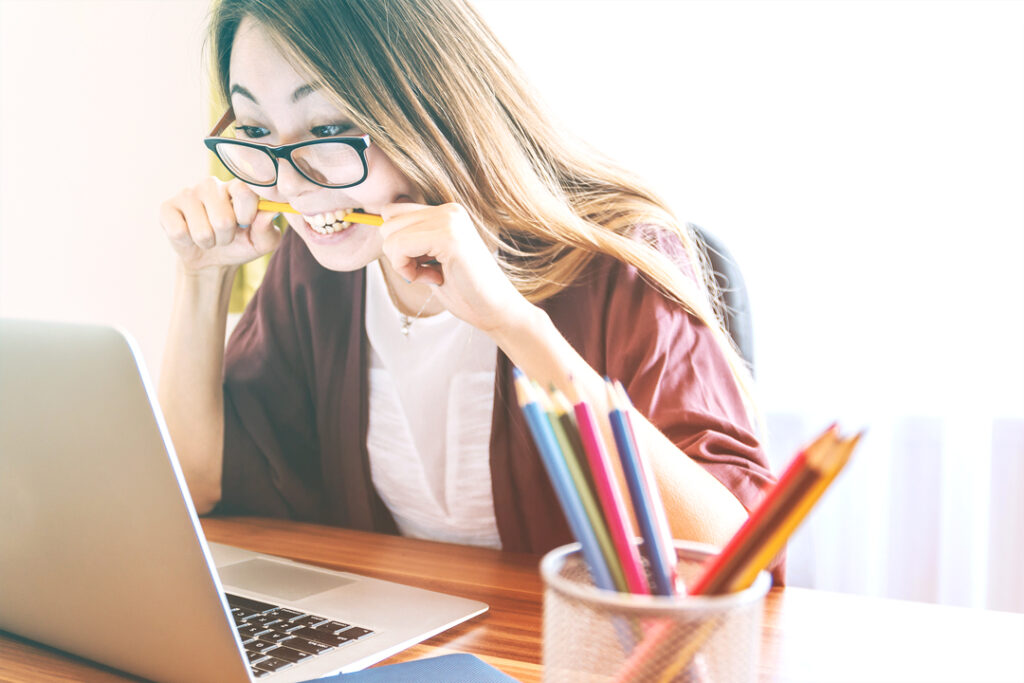 Woman biting pencil