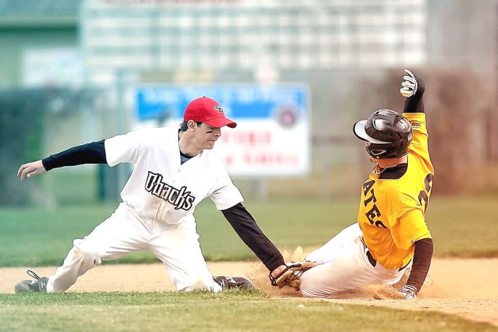 baseball player sliding to the plate