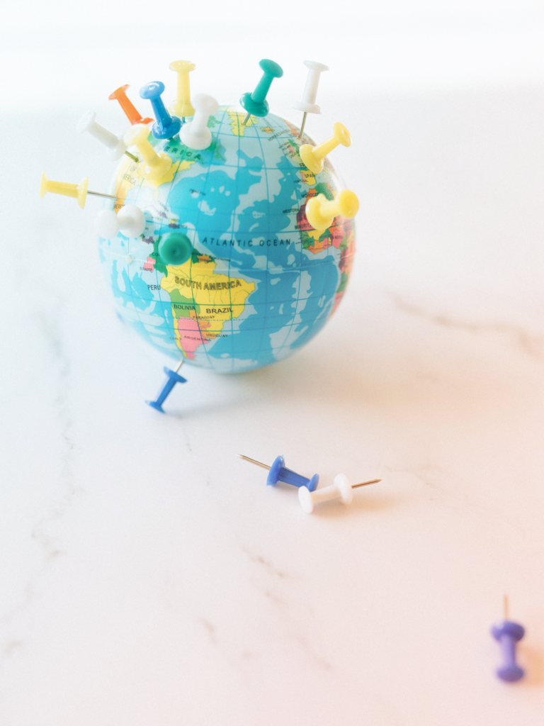 pins on a toy globe