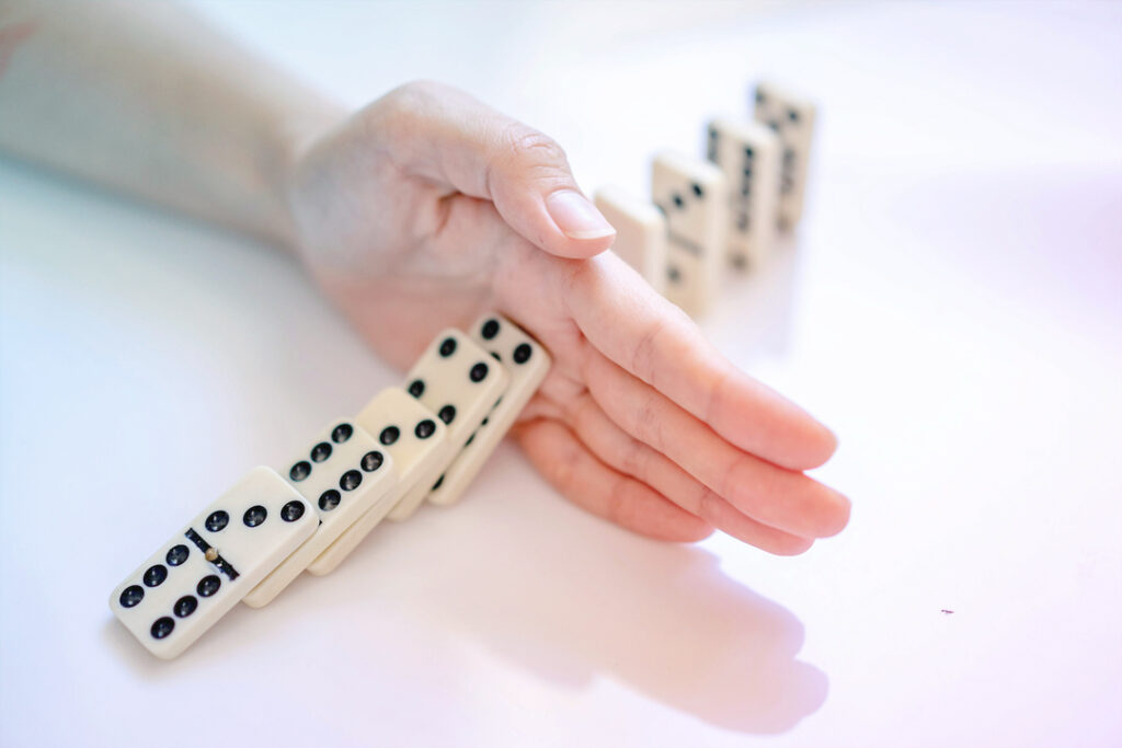 HAND stopping dominos from falling