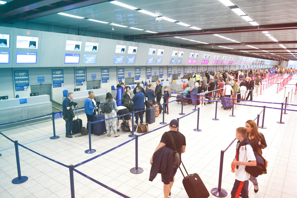 busy luggage drop line at airport