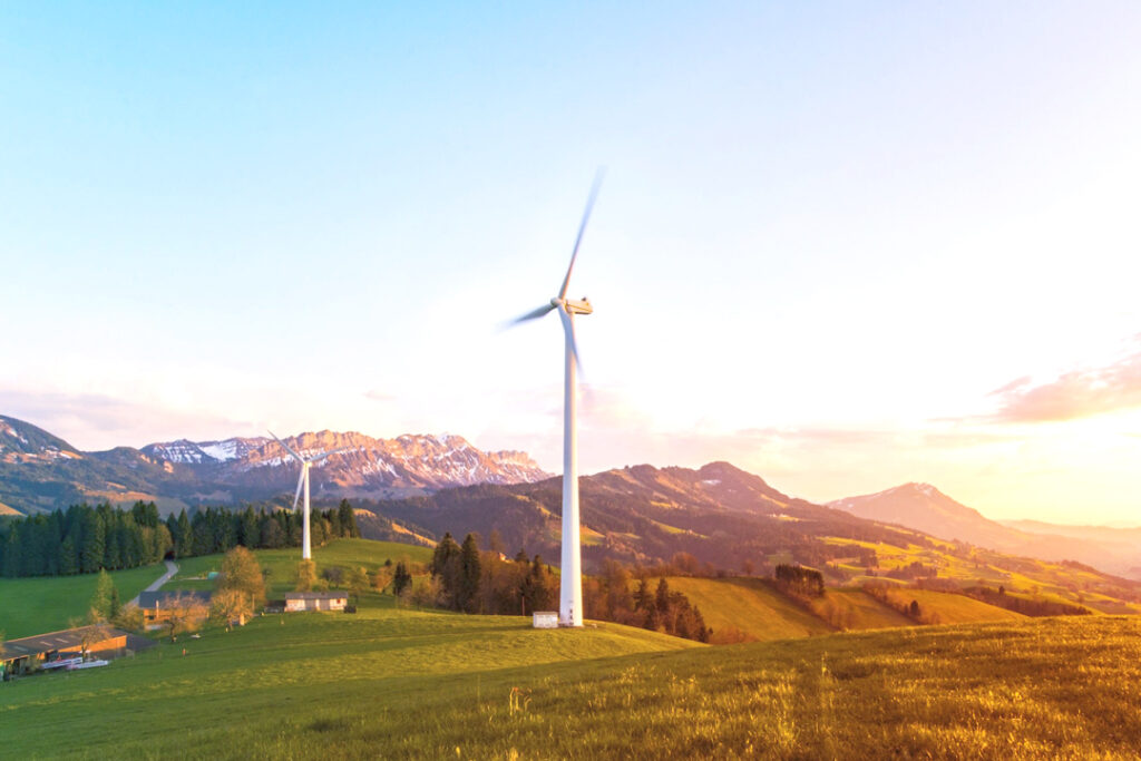 Image of wind turbine on a hill at sunset