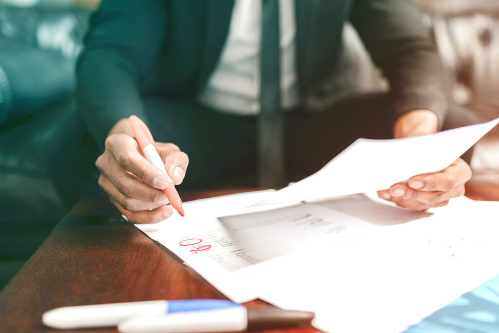 image of business man reviewing paper/reports