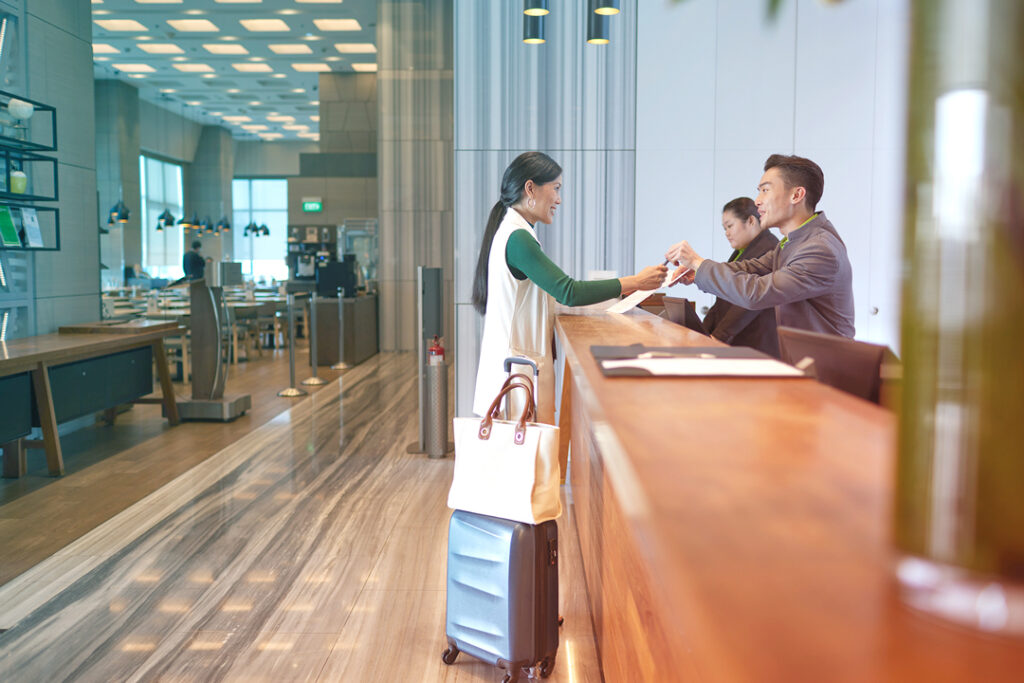 Image of a traveler checking in to a hotel