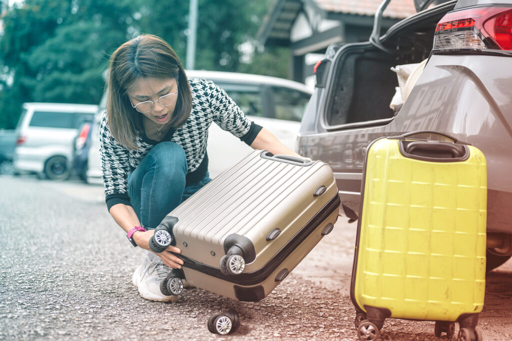 Picture of woman with damaged luggage after she has left the airport - lost luggage help
