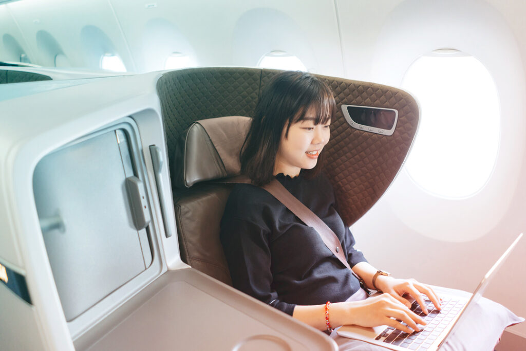 image of a business traveler using her laptop while on a flight
