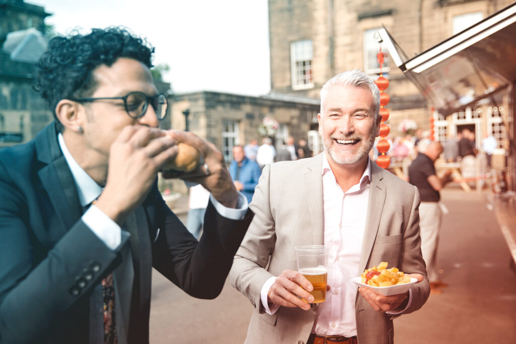 image of a pair of travelers trying street food on their travels - cultural travel