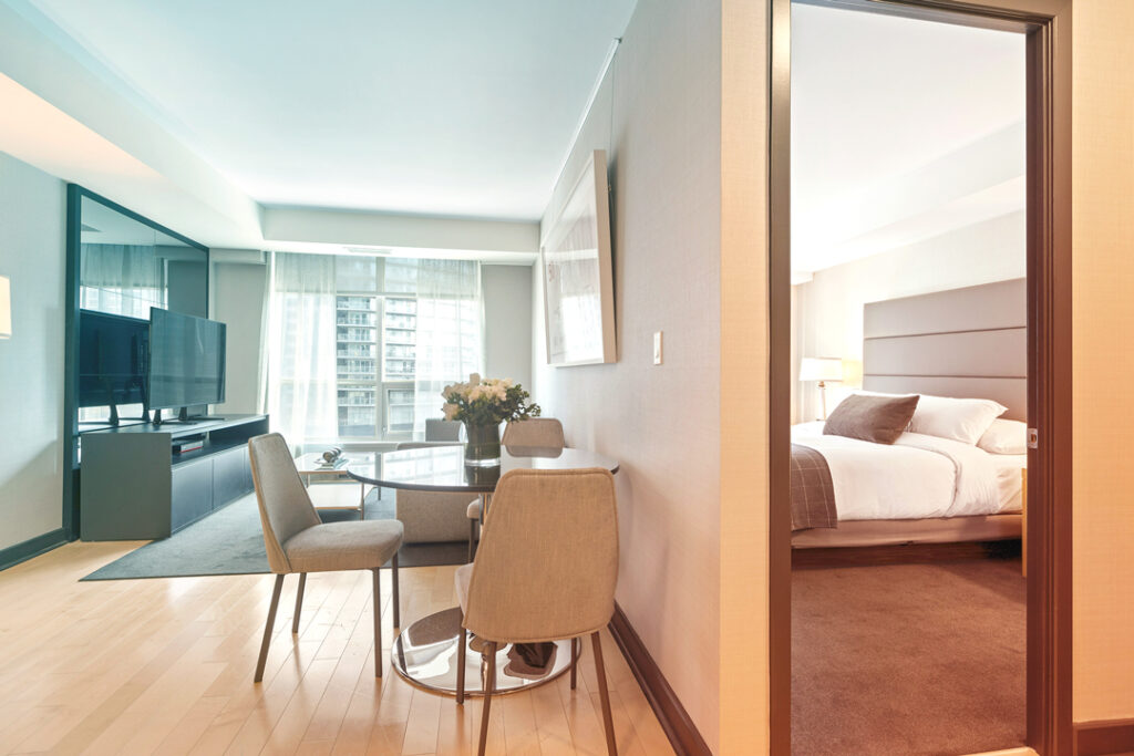 image of a hotel room with a living space and bedroom