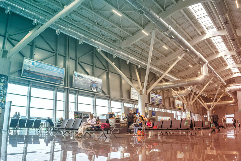 Image of travelers working while waiting in an airport terminal.