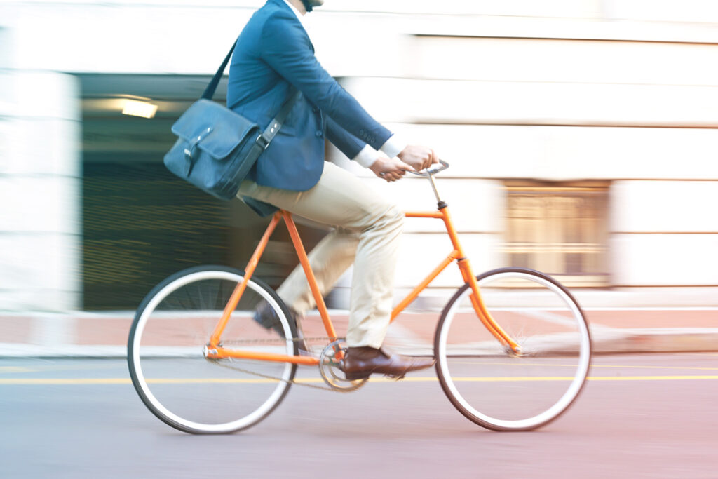 Image of a traveler, riding a bike on the street