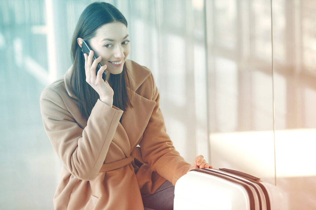Image of a traveler stranded at the airport calling their TMC for help.