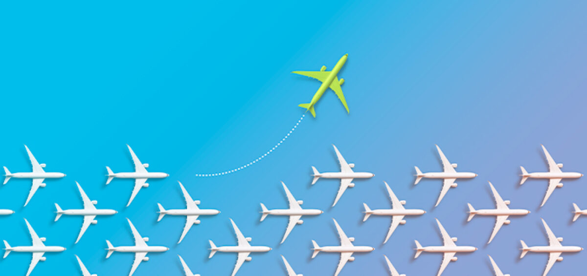 white airplanes in a row with one green airplane traveling away from the others on a blue background