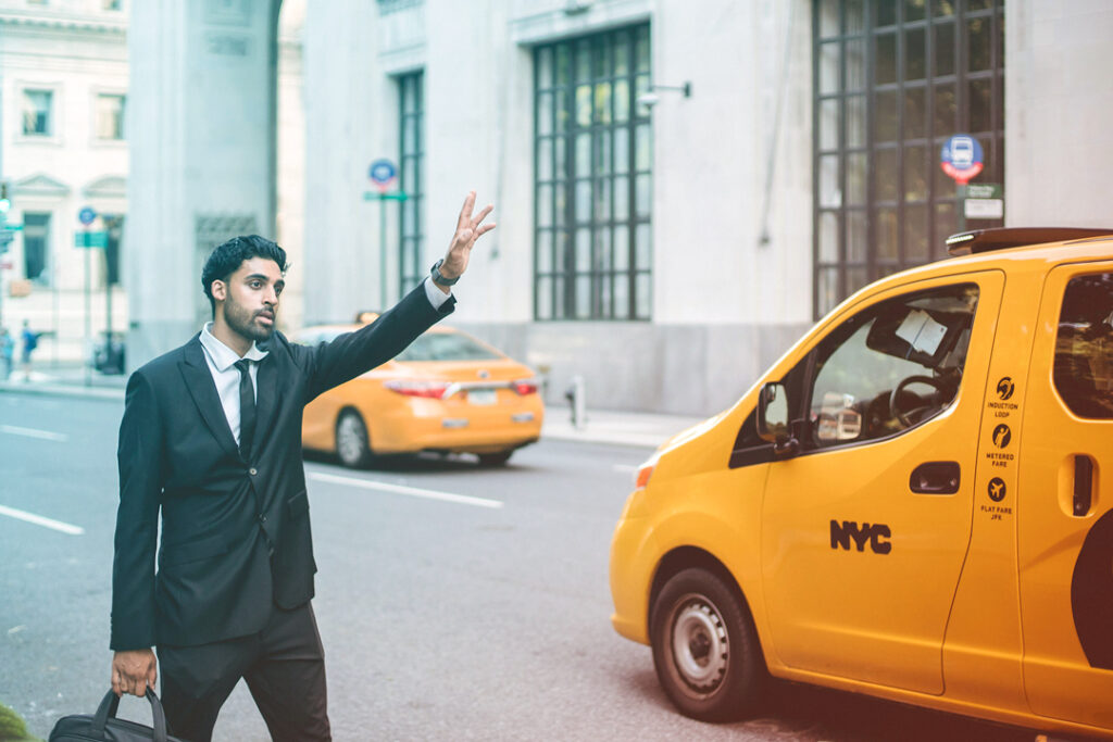 Business traveler getting a taxi.
