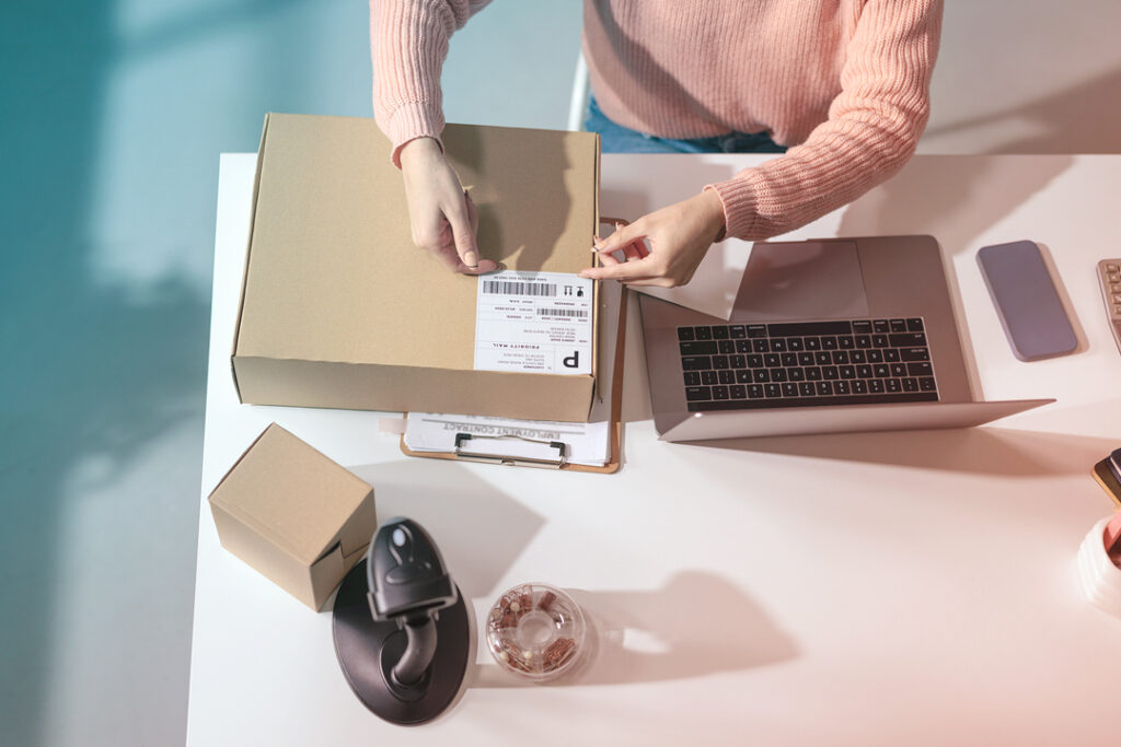 putting a shipping lable on a package