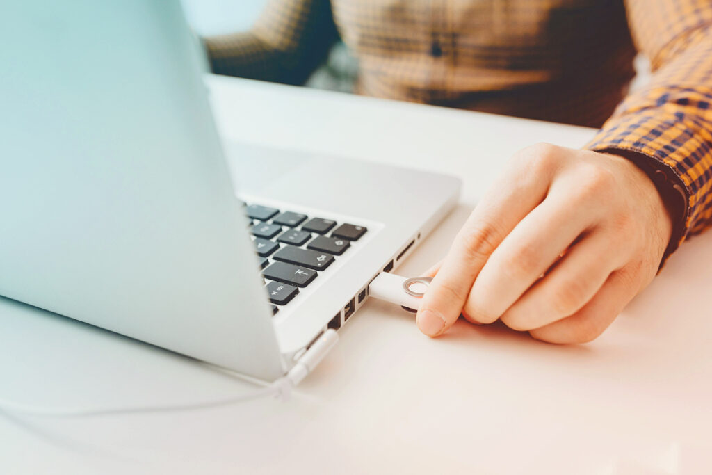 Image of a business traveler, preparing a hard drive with documents to work on during a long haul flight