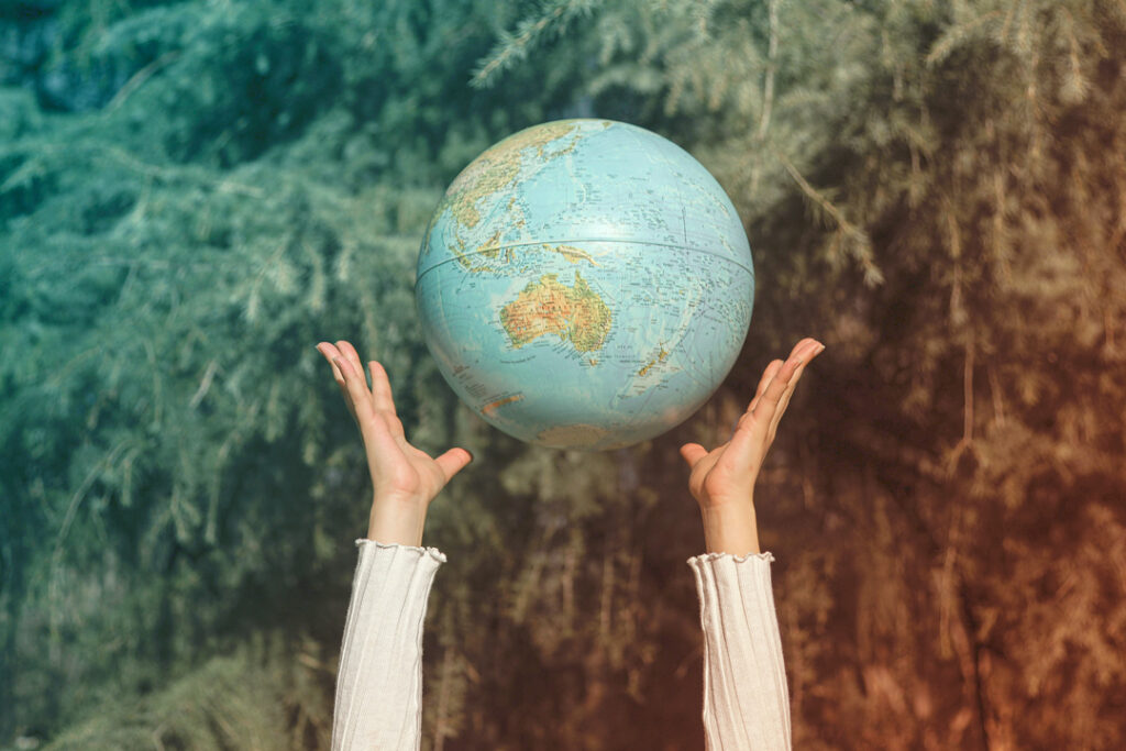 Image of a toy globe being tossed in the air - net zero goals in business travel