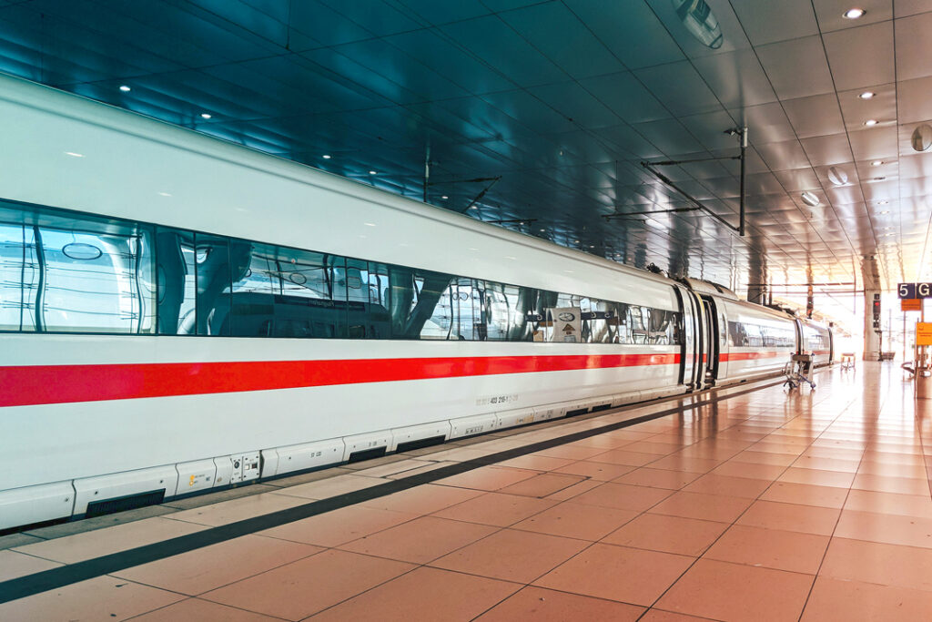 Image of a train station with a train, stopped for passengers