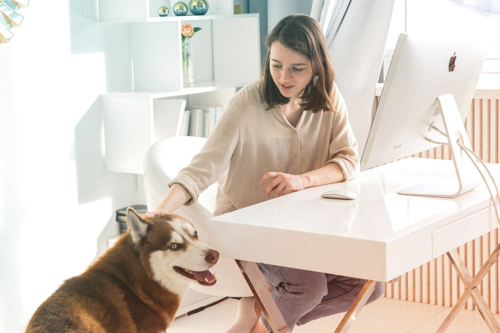 Image of a remote worker in their home office with their dog