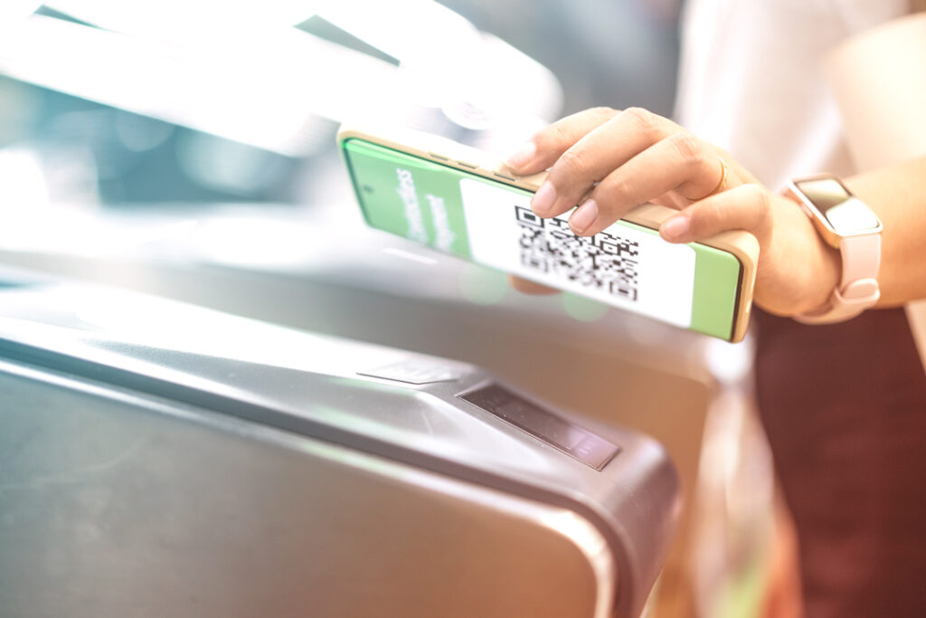 Image of a traveler, scanning their mobile train ticket