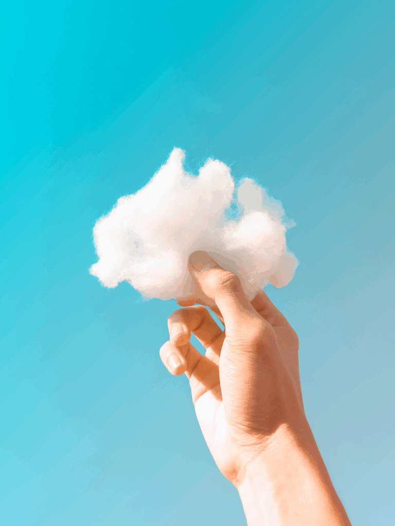 hand holding a cloud representing sustainable travel net zero goals