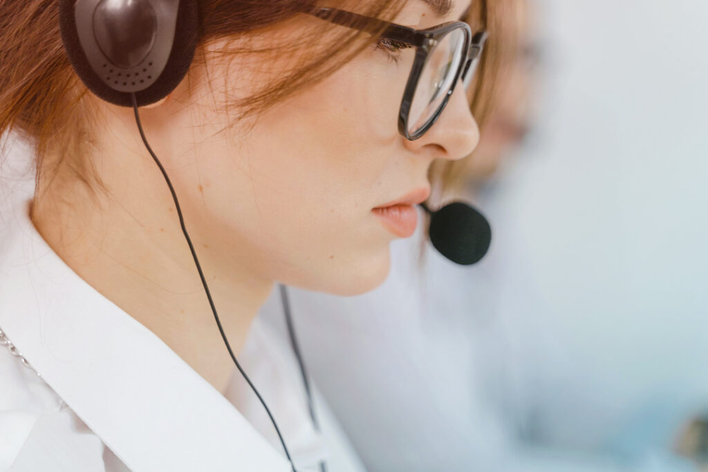 Travel agent wearing a head set at work