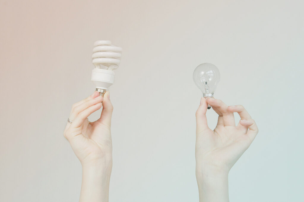 Two diffrent lightbulbs representing self-booking tools and agent booking