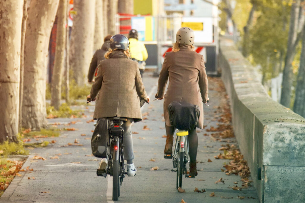 Traveler riding bikes down a street
