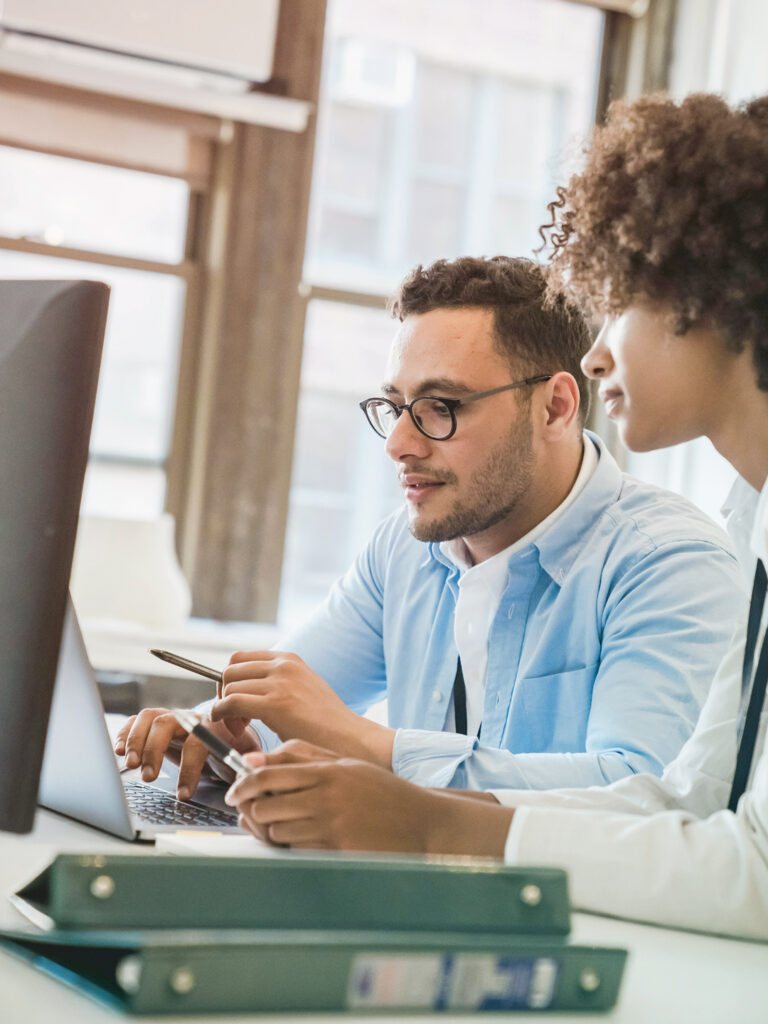 Travel Managers working on a computer planning travel for 2026
