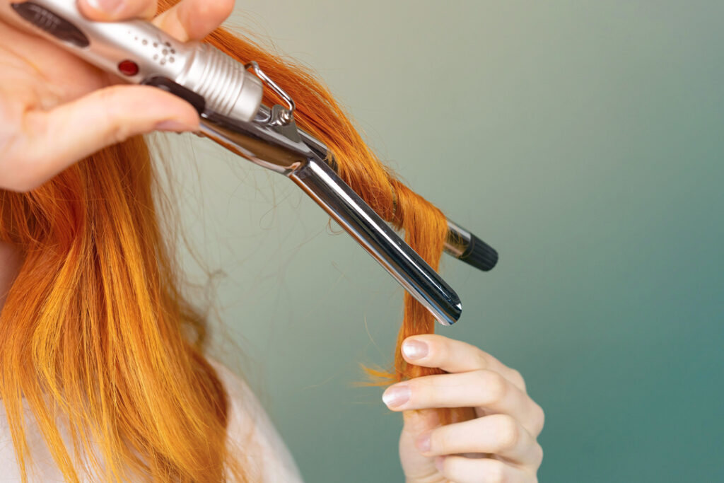 Woman curling her hair 