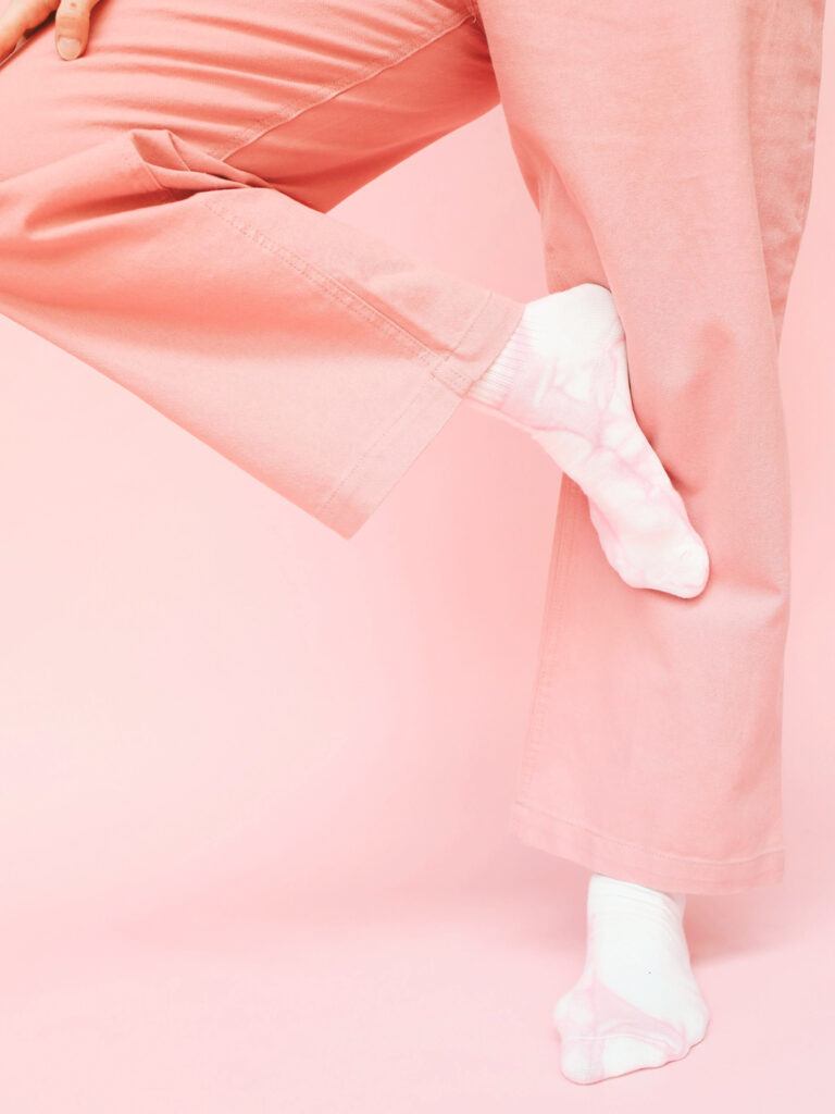 women standing on one leg without shoes, TSA changes - keep ypur shoes on in the airport 