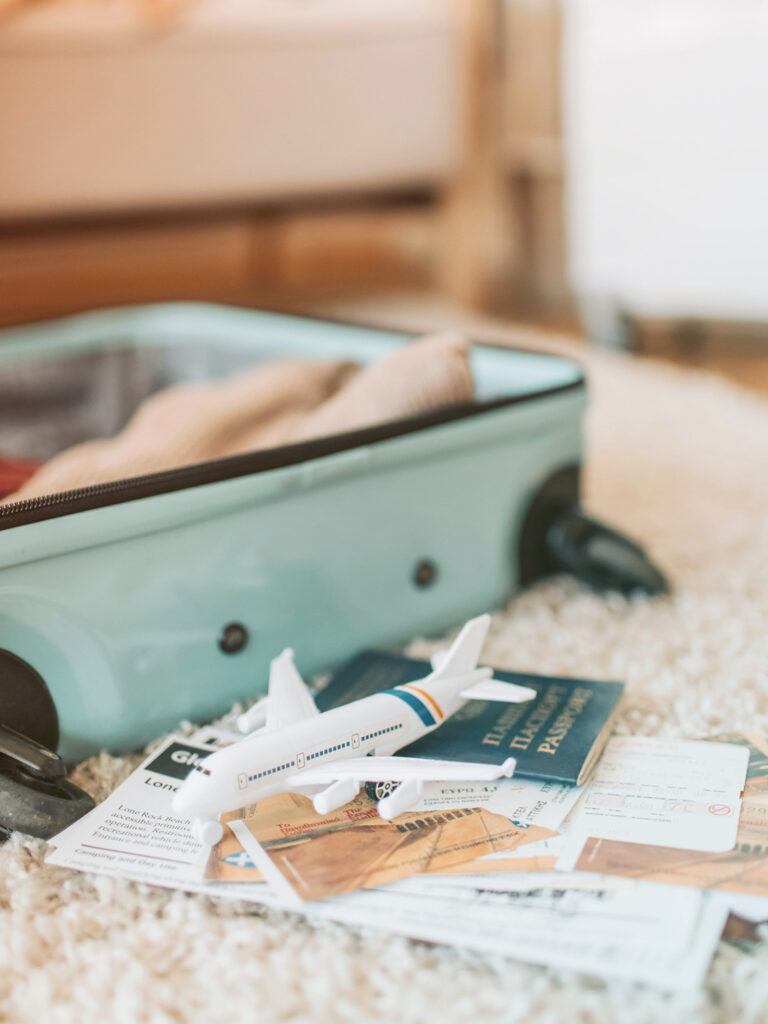 Open suitcase with papers and a model plane 