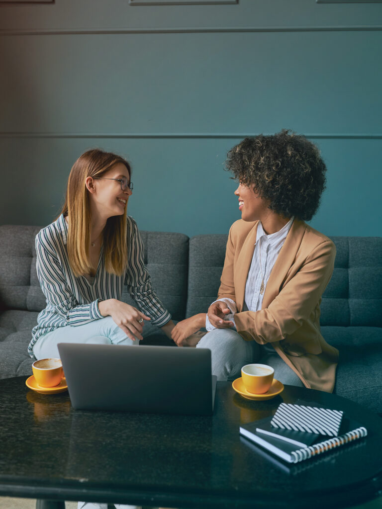 two business women discussing travel management company RFP