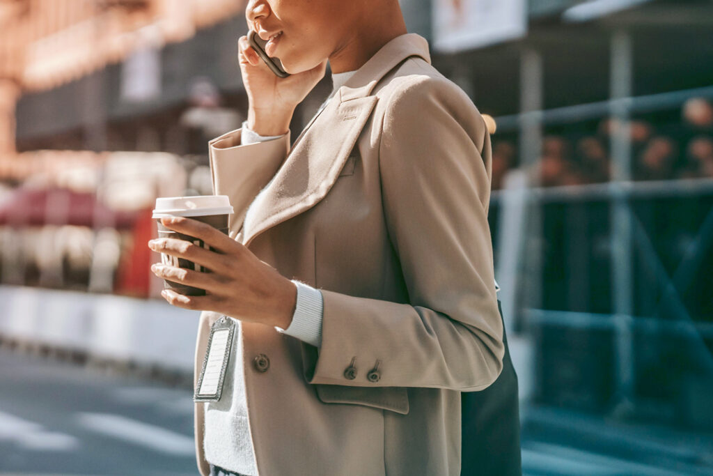 per diem rates in 2026 for meals Traveler on the phone holding a cup of coffee