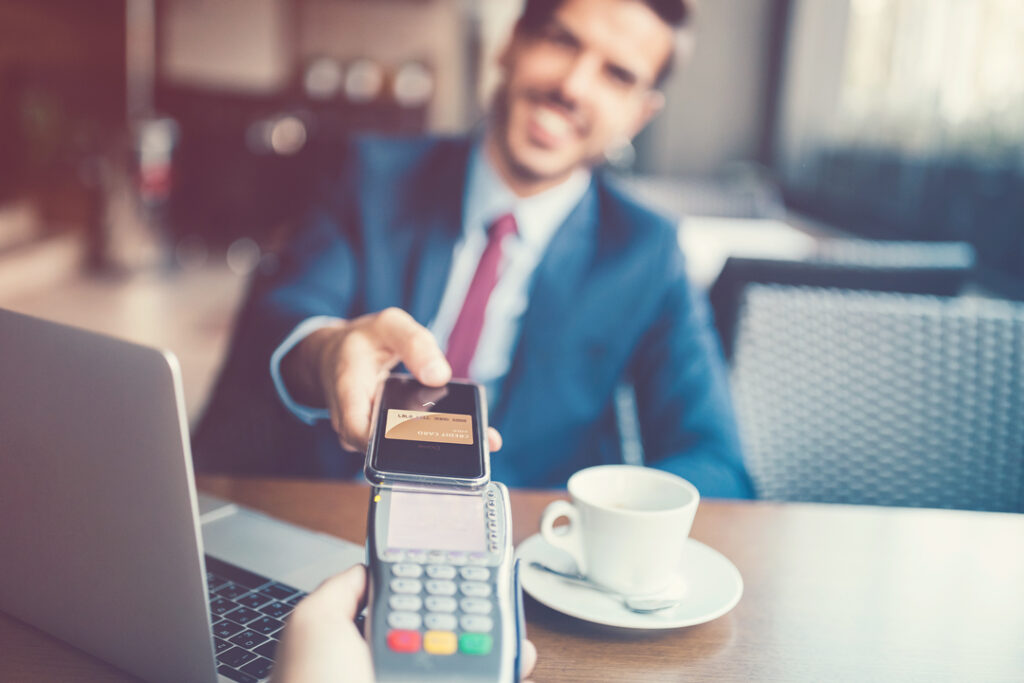 Traveler paying for a coffee - travel budget planning