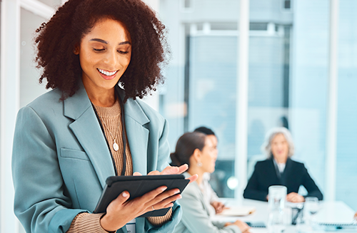 happy business woman on ipad booking travel