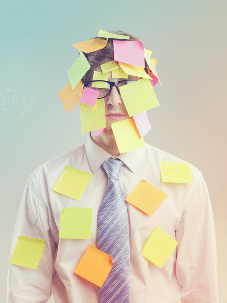 Business man covered in colorful sticky-notes