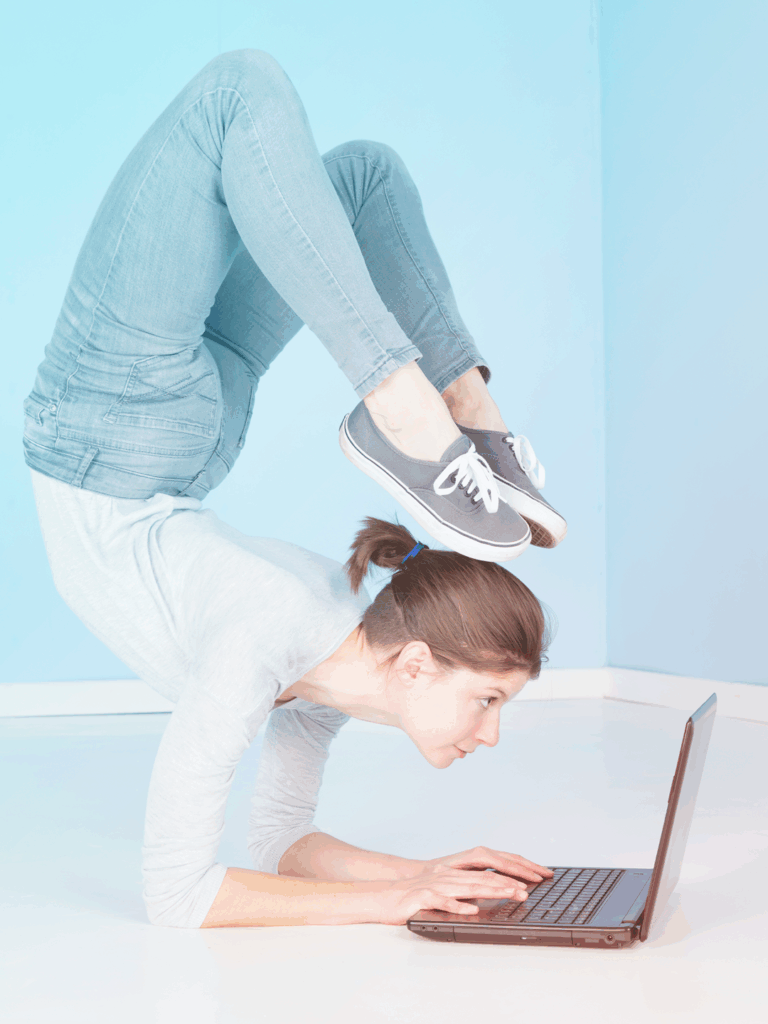 A flexible woman working on her laptop 