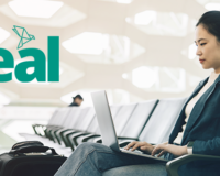 woman at the airport on a laptop with the Teal product logo