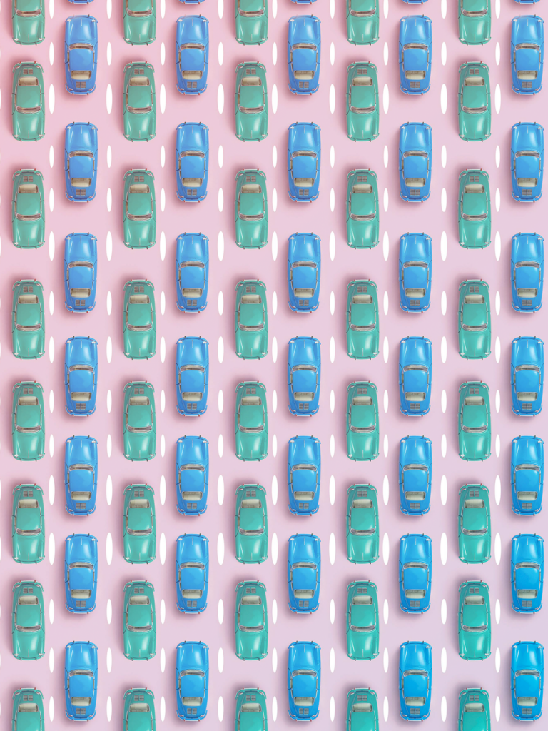 Pink highway full of green and blue cars